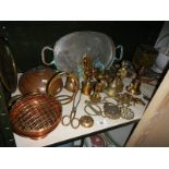 A shelf of brass and copper items.