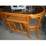 An oval wicker table and 2 chairs.