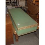 A green Lloyd Loom type long low under-bed blanket box