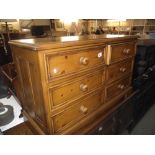 A dark solid pine 6 drawer chest of drawers
