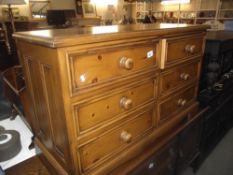 A dark solid pine 6 drawer chest of drawers