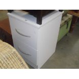 A modern white bedside chest of 2 drawers