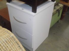 A modern white bedside chest of 2 drawers