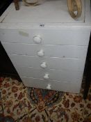 An old white 3 drawer chest.