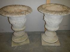 A matching pair of concrete garden urns, 23" tall.