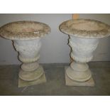 A matching pair of concrete garden urns, 23" tall.