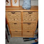 A 6 drawer chest with wicker drawer fronts.