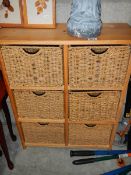 A 6 drawer chest with wicker drawer fronts.