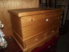 A solid pine blanket box with 2 drawers