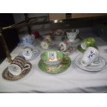 A quantity of porcelain cups and saucers including Wedgwood, Royal Doulton etc.