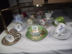 A quantity of porcelain cups and saucers including Wedgwood, Royal Doulton etc.