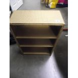 A gold painted Lloyd Loom style shelf unit