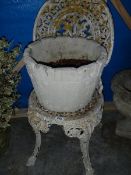 An old cast garden chair and a plant pot.