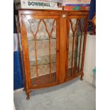 A walnut 2 door display cabinet in good condition.