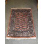 An Eastern wool rug size 63 x 130 cm