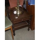 A hall side table with single drawer and a woven wicker undershelf