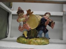 A large glazed pottery figure group of clown musicians