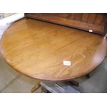 A round pedestal satined oak table