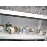 A shelf of jars & condiment holders & egg coddlers
