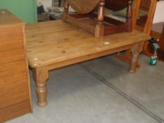 A large square pine coffee table