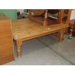 A large square pine coffee table