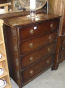 A 1930s 4 drawer oak bedroom chets of drawers