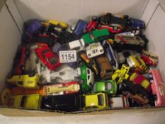 Box containing various die-cast toy vehicles (approximately 60)