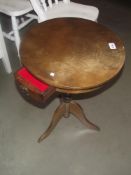 A round oak tripod side table with drawer