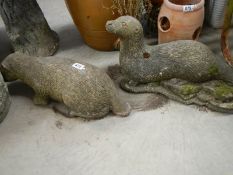 2 otter garden ornaments.