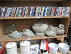 A shelf of garden items including dogs, birds etc.