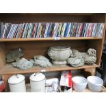 A shelf of garden items including dogs, birds etc.