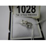 An 18ct white gold and diamond bow ring, size K.