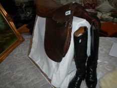 An old leather saddle and pair of riding boots.