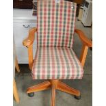 A pine based swivel arm chair.