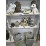 3 shelves of garden ornaments.