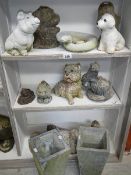 3 shelves of garden ornaments.