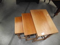 A nest of 3 teak tables.