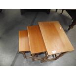 A nest of 3 teak tables.