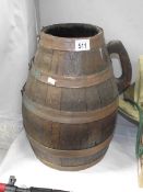A large copper and wood barrel / jug