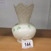 A Belleek vase decorated with shamrocks. 15 cm tall.