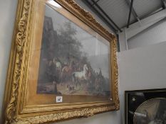 A gilt framed and glazed print of horses.