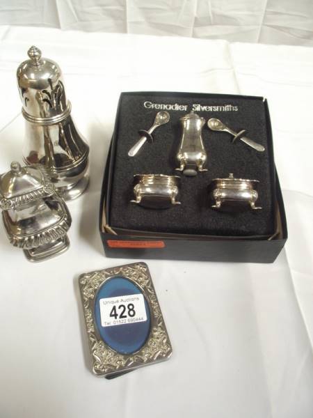 A boxed silver plate cruet set, sugar sifter etc.