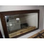 An Edwardian oak bevel edge mirror