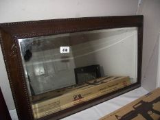 An Edwardian oak bevel edge mirror