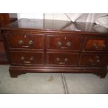 A darkwood stained imitation chest of drawers TV cabinet