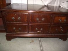 A darkwood stained imitation chest of drawers TV cabinet