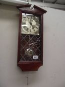 An Emperor quartz wall clock with leaded glass panel.