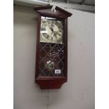 An Emperor quartz wall clock with leaded glass panel.