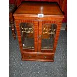 A mahogany glazed two door display cabinet with drawers with Asprey's advertising glazed panels.