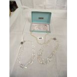 2 crystal necklaces and a pearl necklace
